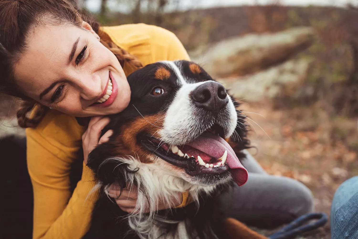 woman hugging dog