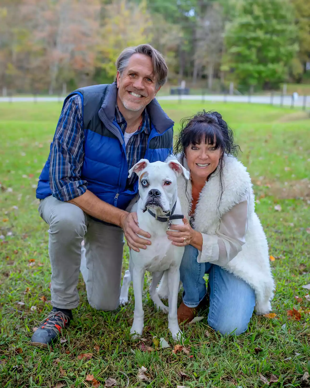 Vertical photo of Nitro the boxer with family